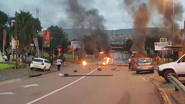 Protesting South Africans set bonfire.