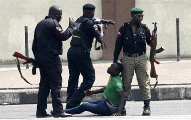 Nigerian Police dragging an offender