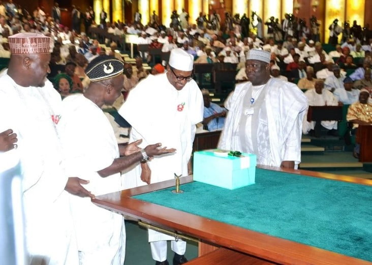 President Buhari presenting the N7.298trn 2017 budget as his national assembly aides watch.