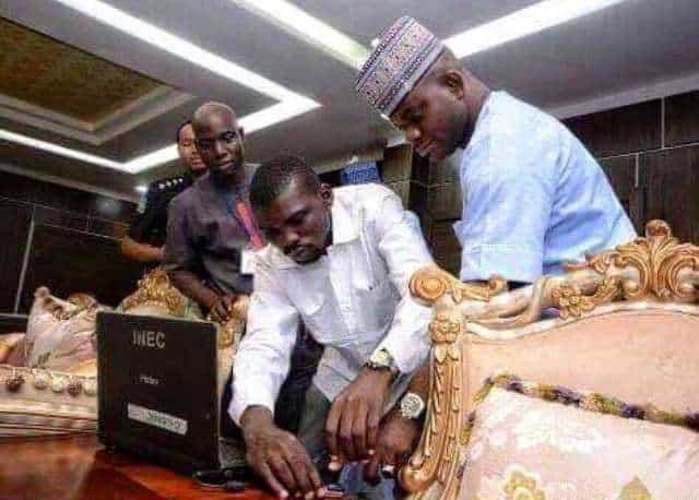 This picture appears to be showing Yahaya Bello, Governor of Kogi State Governor, being registered by an INEC official in his office in Lokoja, but he insists this never took place. Photo Credit: Kogireports