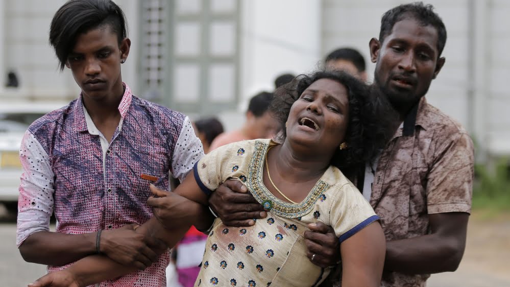 Relatives of a blast victim grieve outside a morgue in Colombo, Sri Lanka 