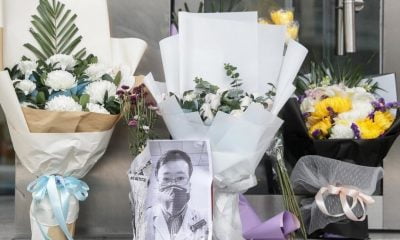 Bouquets of flowers in tribute to Li Wenliang in front of the Wuhan Central Hospital, February 7, 2020.