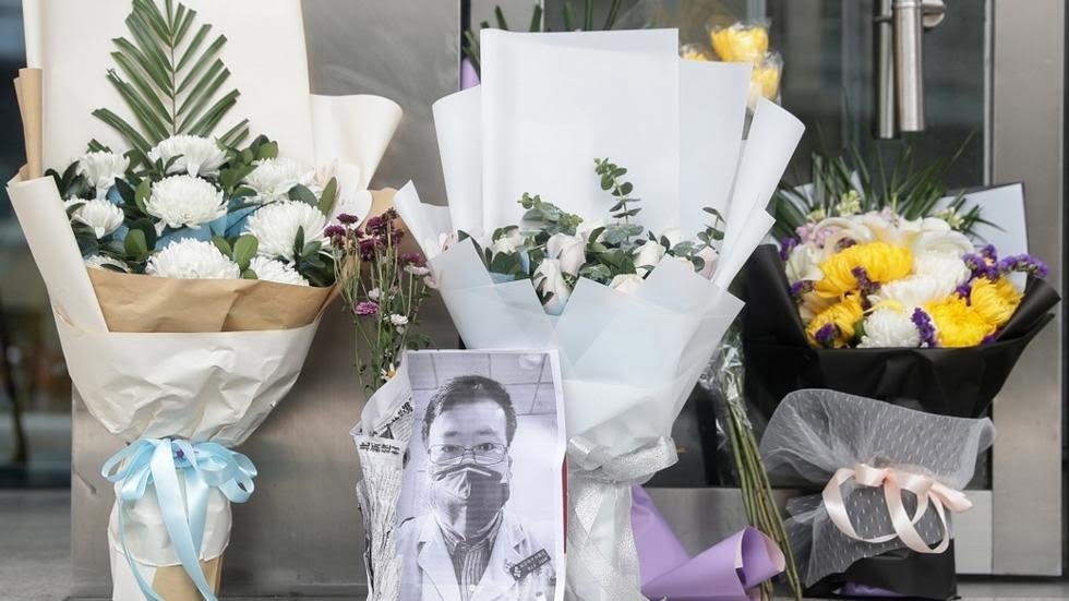 Bouquets of flowers in tribute to Li Wenliang in front of the Wuhan Central Hospital, February 7, 2020.