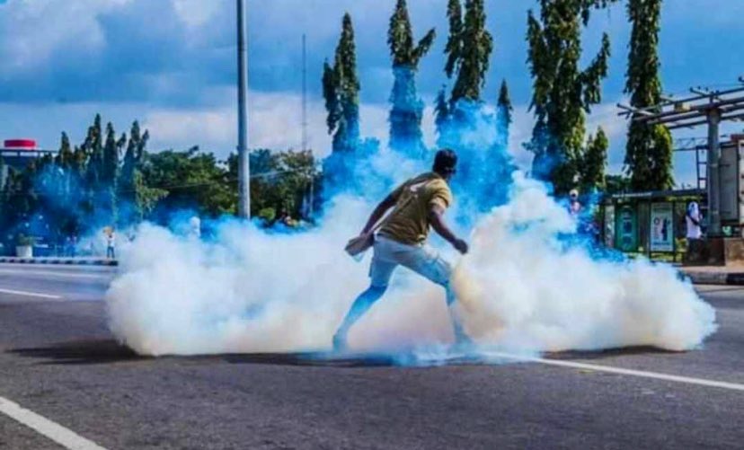 ENDSARS: Man Displays Boldness, Throws Tear Gas Canister On Policemen  [Photos] | Naija News