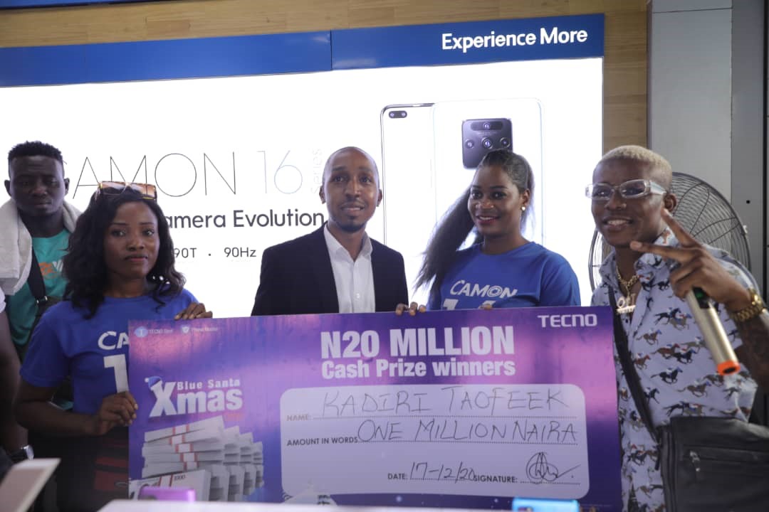  One of the winners being presented with a cheque of 1Million Naira by Small Doctor