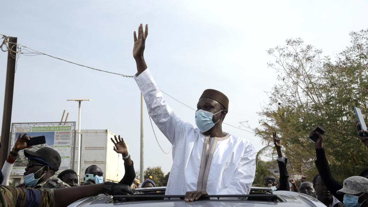 Senegal's opposition leader Ousmane Sonko greets supporters on his way to court in Dakar on March 3, 2021. © Seyllou, Nigeria News