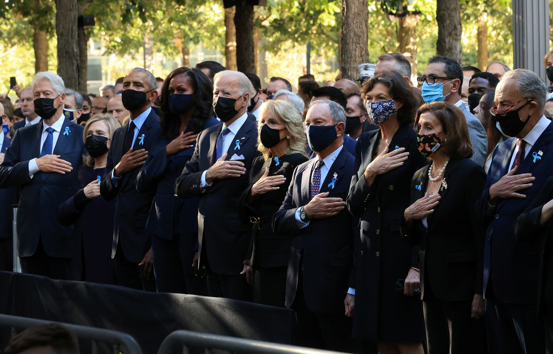 U.S. former President Bill Clinton, former First Lady Hillary Clinton, former President Barack Obama, former First Lady Michelle Obama, President Joe Bien, First Lady Jill Biden, former New York City Mayor Michael Bloomberg, Bloomberg's partner Diana Taylor, Speaker of the House Nancy Pelosi (D-CA) and and Senate Minority Leader Charles Schumer (D-NY) stand for the national anthem during the annual September 11 Commemoration Ceremony at the National 9/11 Memorial and Museum in New York City, U.S., September 11, 2021.