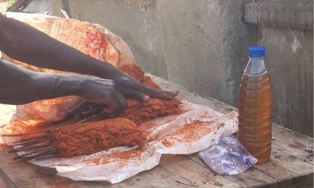 Another Suya seller at Life Camp, Abuja where he is preparing for the day's sale. Beside him is the oil he uses to prepare his suya. Photo credit: Adesola Ikulajolu