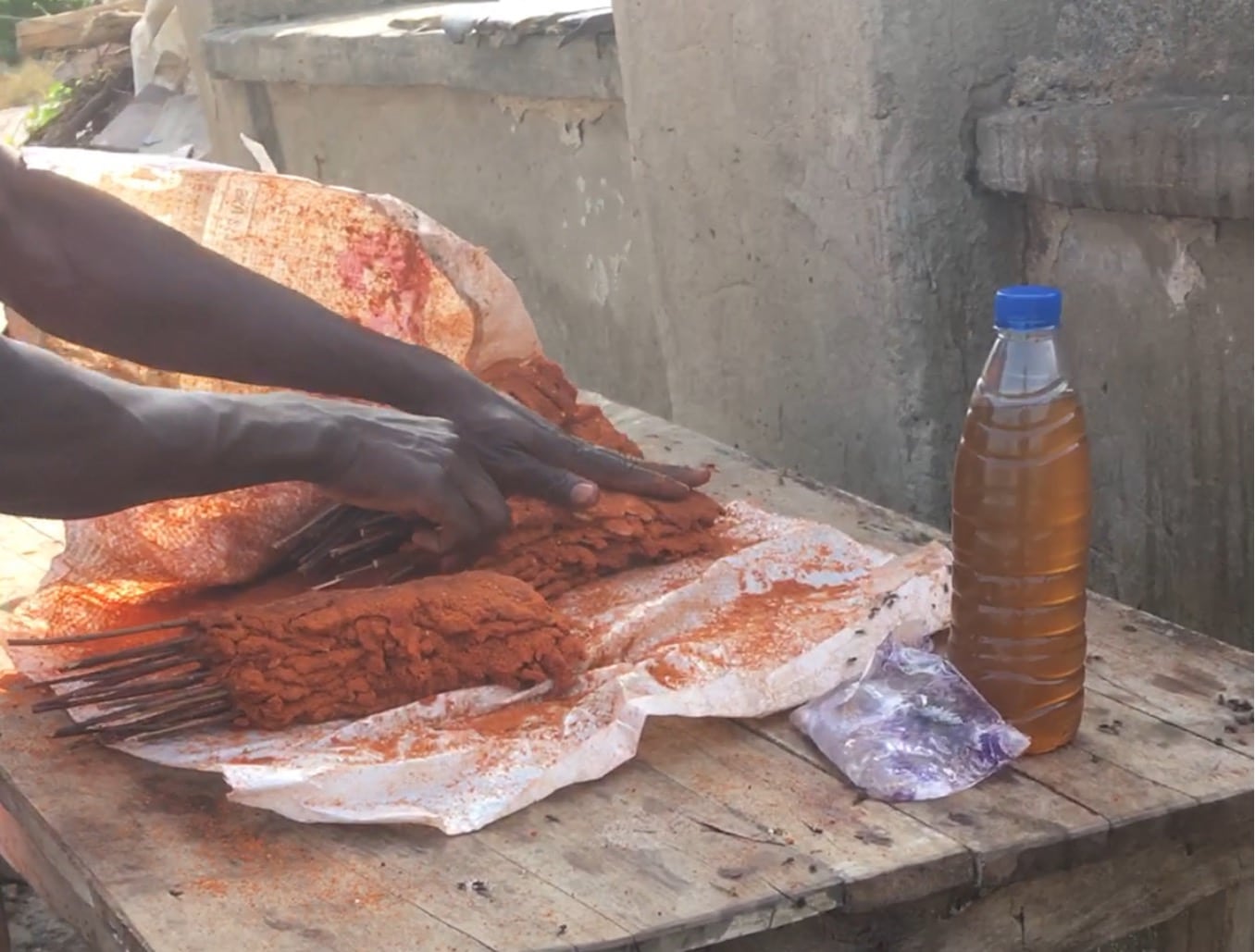 Another Suya seller at Life Camp, Abuja where he is preparing for the day's sale. Beside him is the oil he uses to prepare his suya. Photo credit: Adesola Ikulajolu