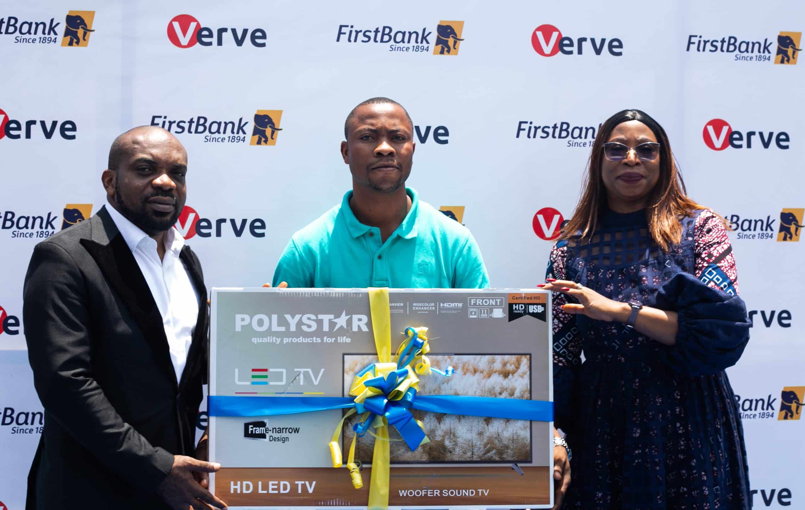 L-R Chidike Oluaoha, Group Head/Growth Marketing, Pay Token; Olowu Ibrahim, representing Olowu Yakubu, winner of 32" TV and Folasade Femi- Lawal, Head, FirstBank Cards and Messaging Business at the Prize Presentation to winners of the recently concluded FirstBank Verve Card Transact and Win Promo.
