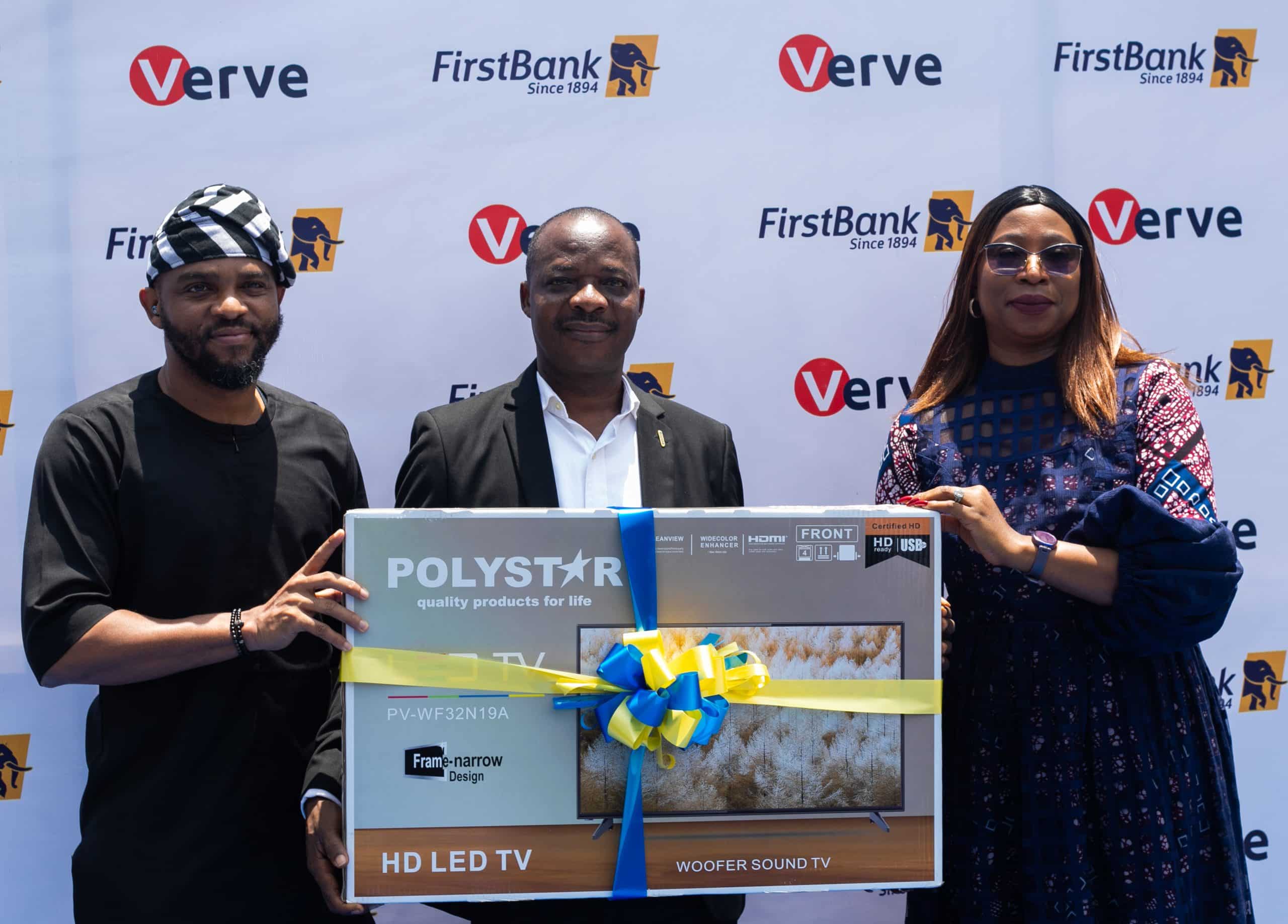 L-R Abolaji A Akilo; Team Lead,  Issuer Management, Verve International;  Adewumi Isaac Adeyoju, 32" TV winner and Folasade Femi - Lawal, Head, Cards and Messaging Business, FirstBank at the Prize Presentation to winners of the recently concluded FirstBank Verve Card Transact and Win Promo.