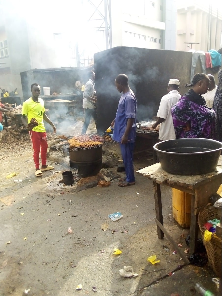 Usman and his colleagues at Wuse Market preparing Suya meat for sale. Photo credit: Adesola Ikulajolu