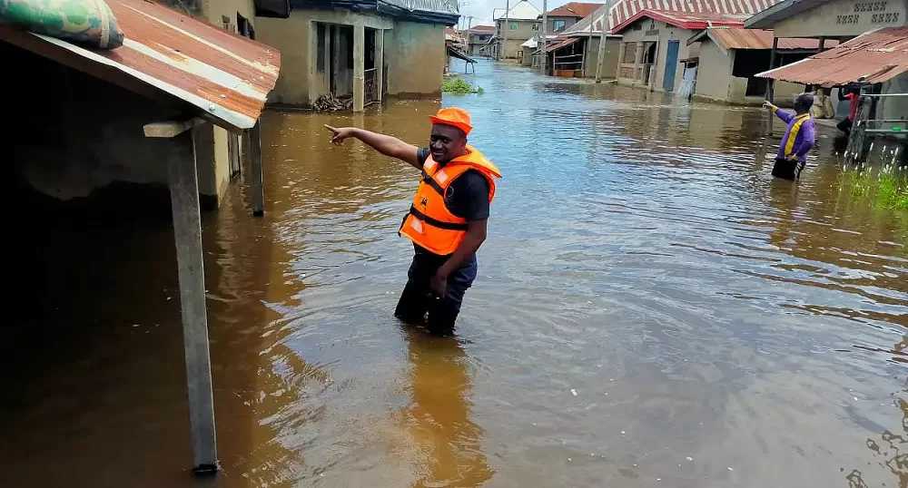 A rescue worker in a flooded street following a boat accident in Anambra, Nigeria, October 7, 2022.