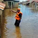 A rescue worker in a flooded street following a boat accident in Anambra, Nigeria, October 7, 2022.