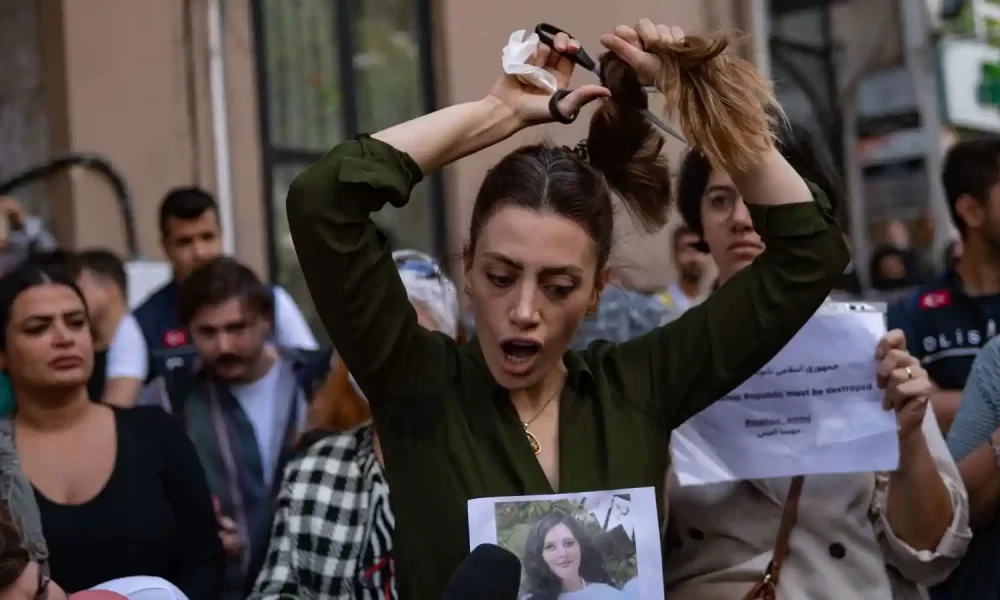 Nasibe Samsaei, an Iranian woman cuts her ponytail off during a protest following the death of an Iranian woman after her arrest by the country's morality police in Tehran