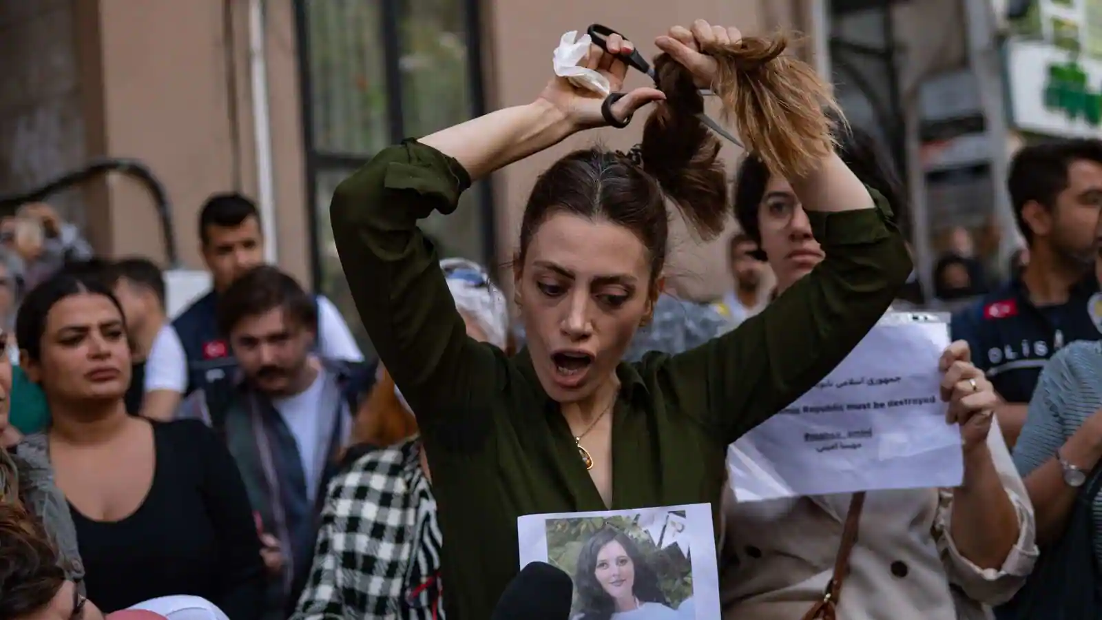 Nasibe Samsaei, an Iranian woman cuts her ponytail off during a protest following the death of an Iranian woman after her arrest by the country's morality police in Tehran