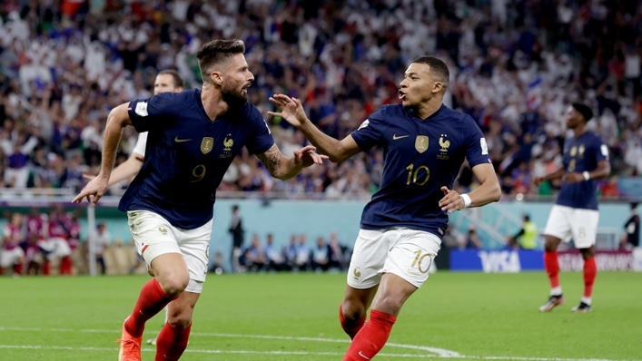Olivier Giroud (L) and Kylian Mbappe (R) celebrate the former scoring for France against Poland at the World Cup