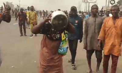 Reactions As Woman Appears At Mowe Protest Drinking Garri From Pot - [Video]