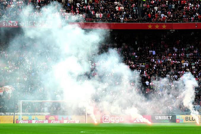 Ajax fans threw flares on the pitch.