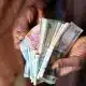 Tinubu, Dangote Receive Accolades As Ex-Presidential Aide Reacts To Dollar To Naira Exchange Rate