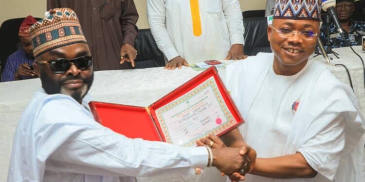 Reactions As Ododo Kneels To Present Certificate Of Return To Yahaya Bello (Video)