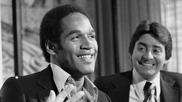 O.J. Simpson, left, smiles next to San Francisco 49ers owner Edward March 24, 1978 file photo: DeBartolo Jr. at a news conference where the 49ers announced that Simpson had been traded to them from the Buffalo Bills, in San Francisco.