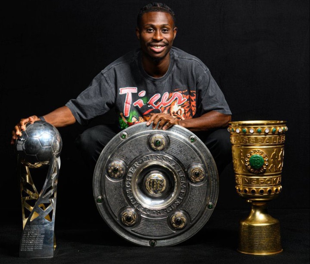 Nathan Tella posing with the titles he has won at Bayer Leverkusen after signing a new deal with the club earlier today, March 24, 2026.