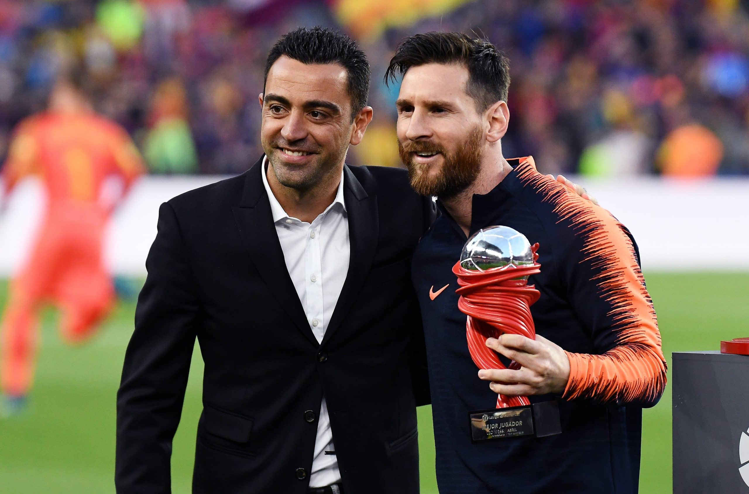 File photo of Xavi Hernandez and Lionel Messi.
