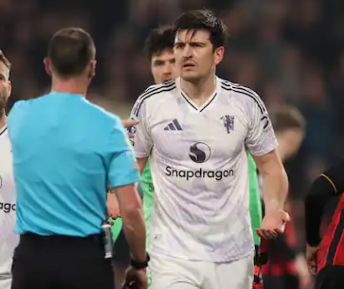 Harry Maguire confronting a referee during Manchester United clash with Bournemouth.