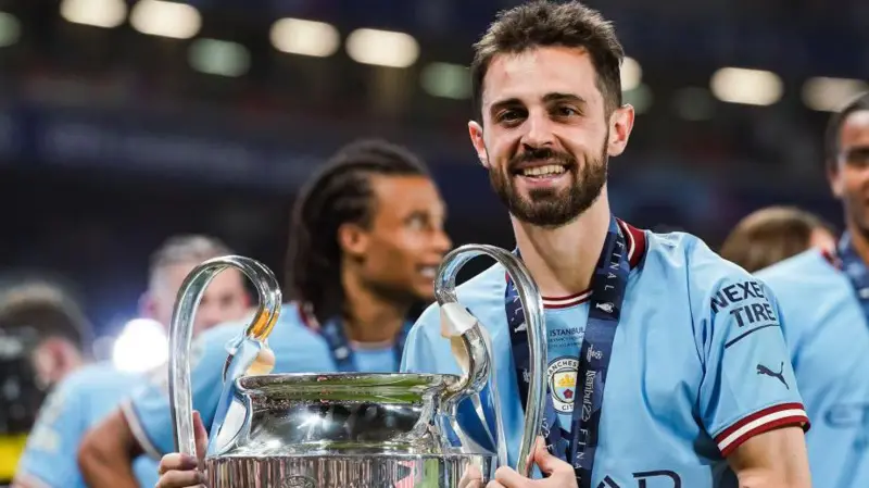 Outgoing Manchester City star, Bernardo Silva posing with the UEFA Champions League title.