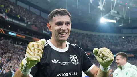 Aston Villa goalkeeper Emiliano Martinez celebrates Europa League title win. 