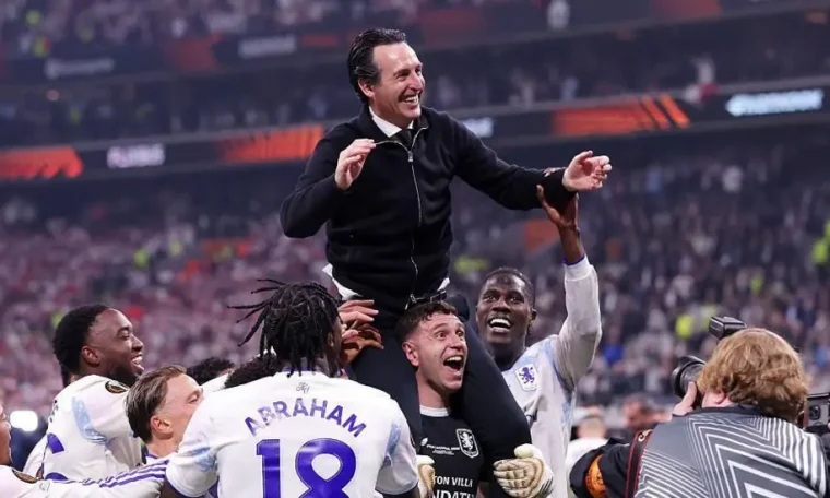 Aston Villa players celebrate with their coach, Unai Emery after leading them to their first European title in 30 years.