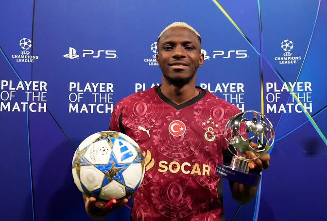 Victor Osimhen posing with the man of the match award and the match ball after a Champions League match.