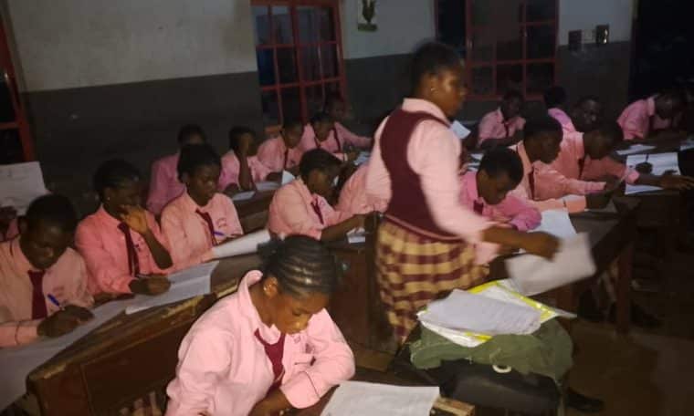 Students writing WAEC at night
