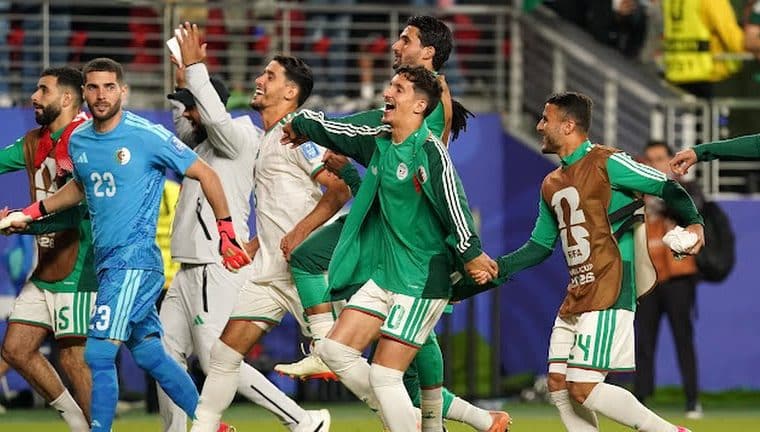 Algerian players celebrate their World Cup match win over Jordan.