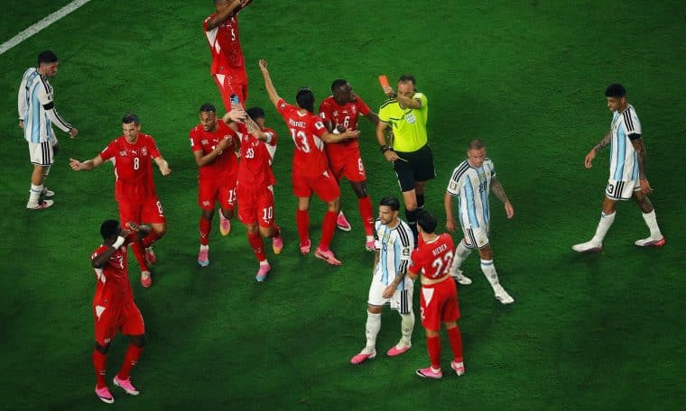 Referee Joao Pinheiro shows a red card to Breel Embolo of Switzerland for simulation during the 2026 FIFA World Cup.