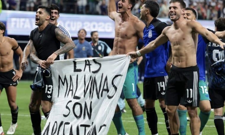 Argentina players celebrating their World Cup Semi-final win over England with a politically motivated banner.