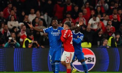 Gianluca Prestianni of Benfica covering his mouth to talk to Vinicius Junior of Real Madrid during a Champions League game.