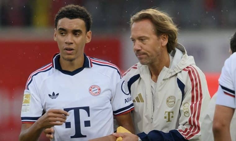 Jamal Musiala being helped out of the pitch by Bayern Munich medical team after collapsing.
