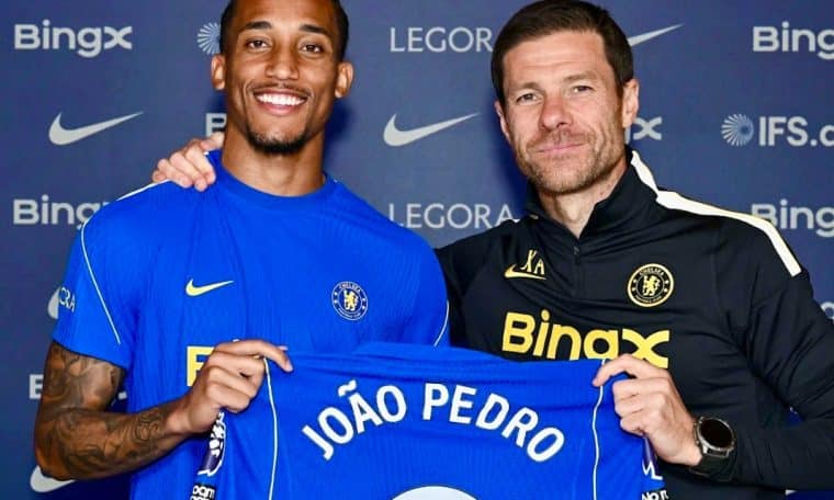 Joao Pedro posing with Chelsea manager Xabi Alonso after extending his contract with the club.