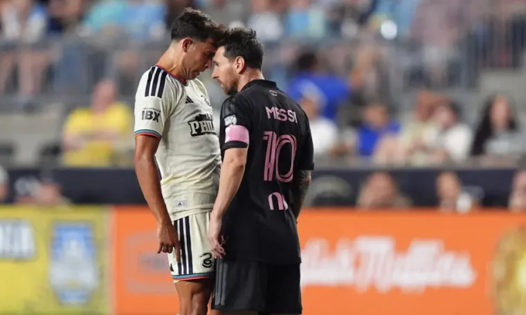 Quinn Sullivan and Lionel Messi in confrontation during an MLS game.