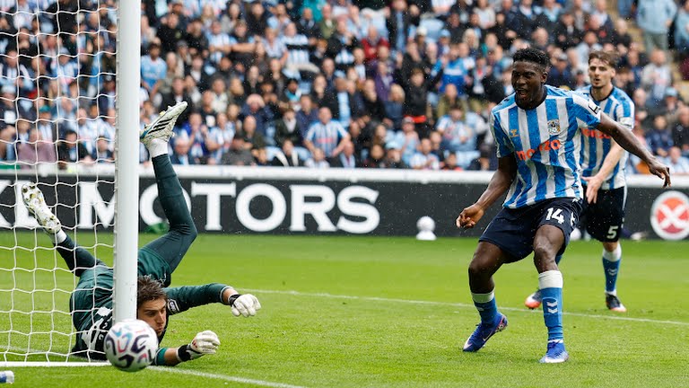 Coventry City's Taiwo Awoniyi in action with Hull City's Konstantinos Tzolakis.