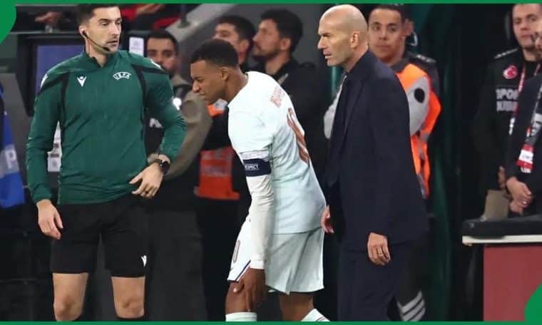 Kylian Mbappe making his way to the bench with coach Zinedine Zidane behind him during France's clash with Turkey on Friday, September 25.